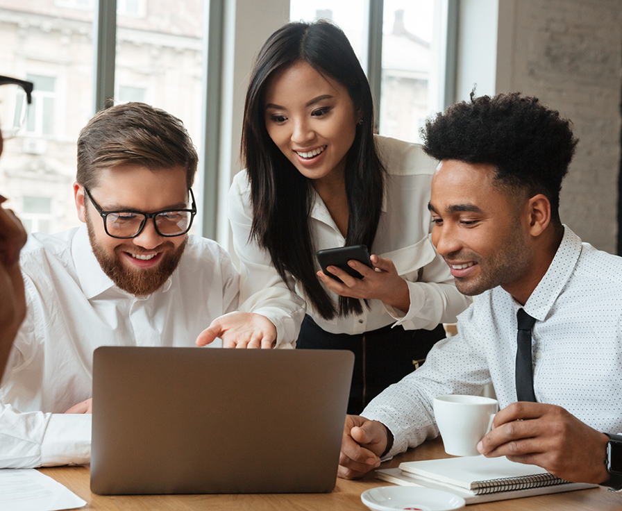 male and female coworkers looking at a laptop