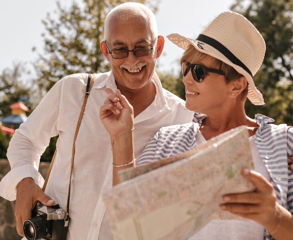 Elderly tourist couple pointing at landmarks